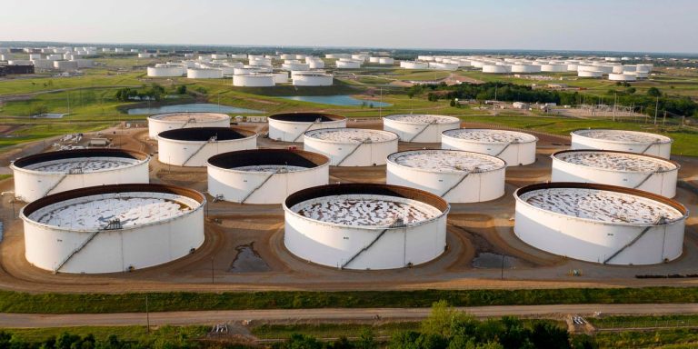 Oil prices settle at a 5-week low as U.S. gasoline supplies post a sharp weekly climb