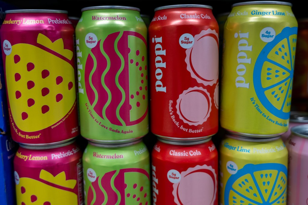 NEW YORK, NEW YORK - MARCH 17: Cans of Poppi soda are displayed inside of a store on March 17, 2025 in New York City. On Monday, PepsiCo announced that it is buying prebiotic soda brand Poppi for nearly $2 billion. (Photo by Spencer Platt/Getty Images)